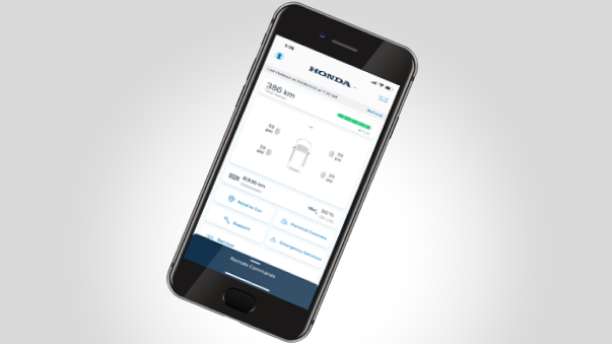 Closeup of a smartphone on white space with the HondaLink™ app interface displayed. 