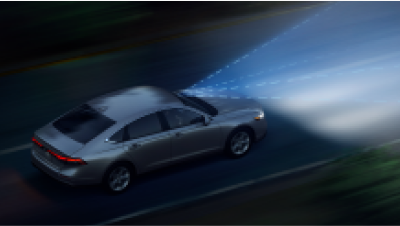 View of Accord driving at night. Blue sensor lines and waves emit from the front. 