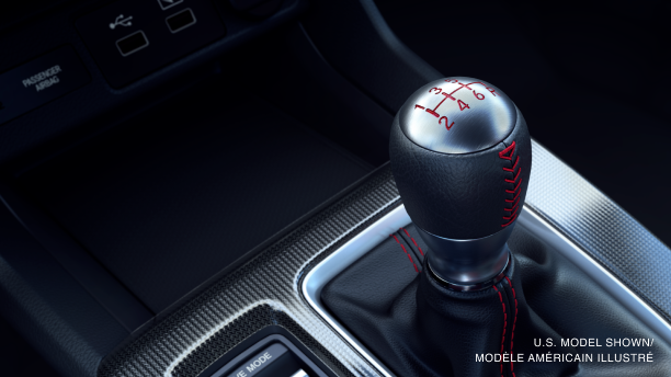 Closeup of wireless charging pad in centre console above the gear shifter. 
