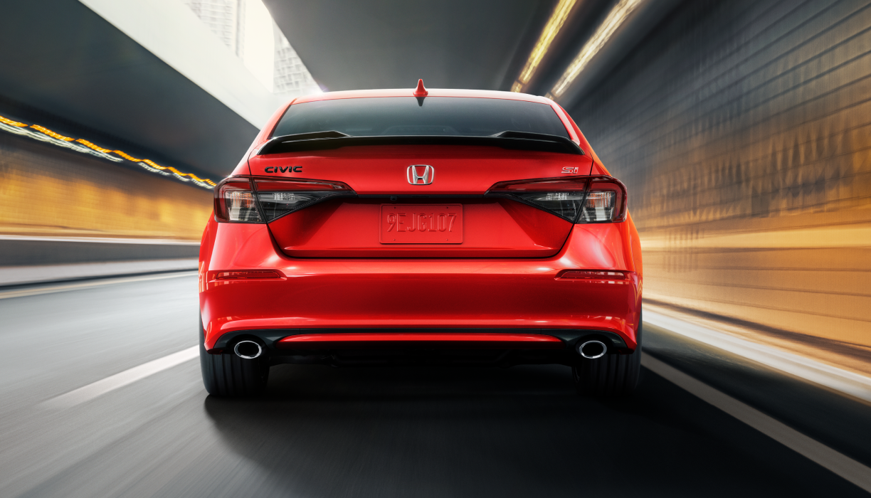 Rearview of red Civic Si driving in tunnel.
