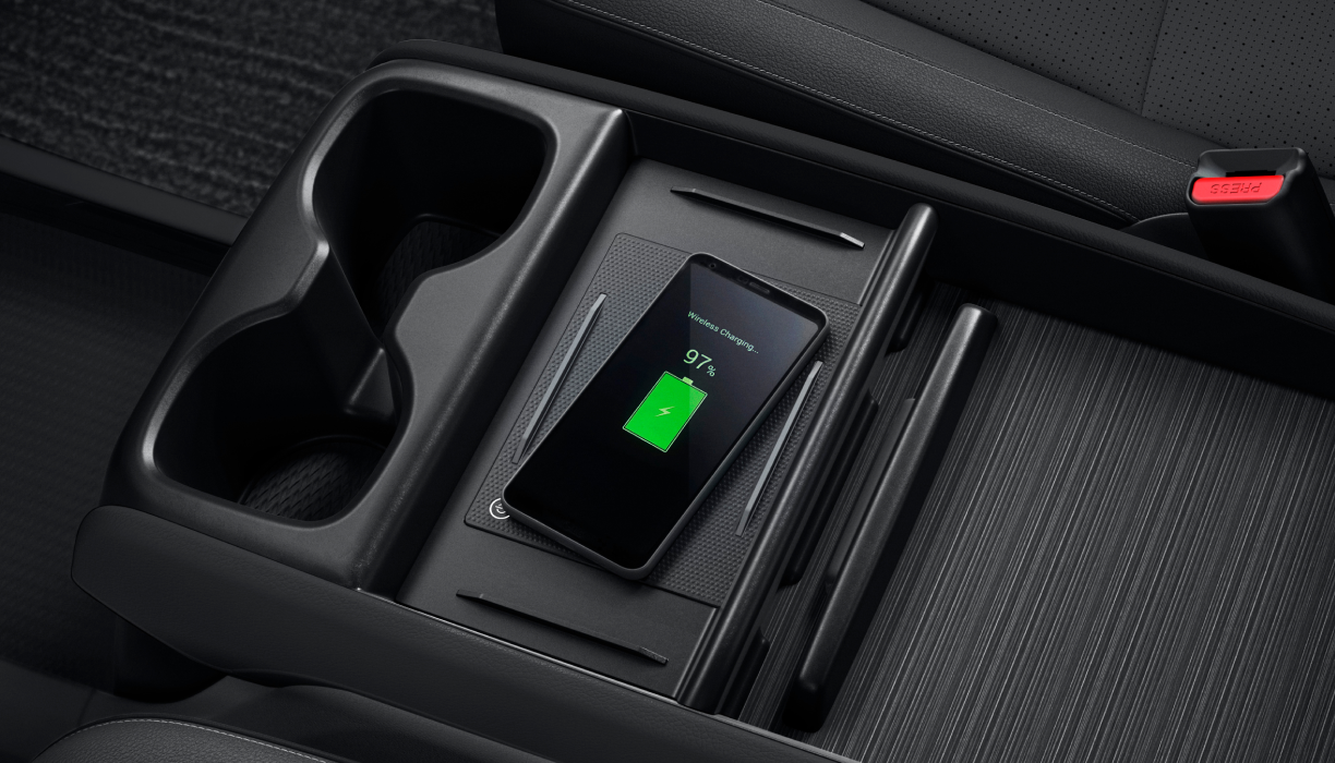 Bird’s eye view of phone charging on pad in centre console.