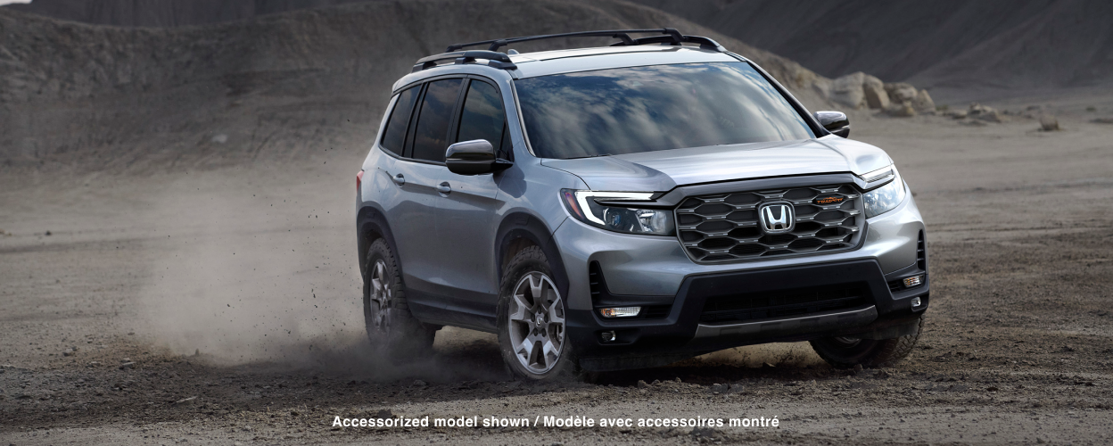 3/4 front view of grey Passport off-roading in desert.