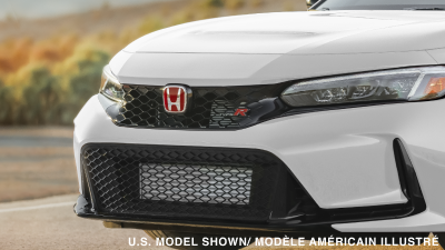 3/4 closeup of a Type R’s red “Honda” logo and “Type R” badging.