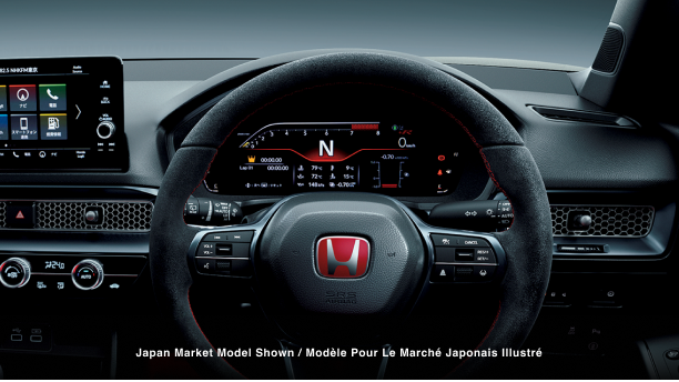 Closeup of steering wheel and TFT driver meter display, featuring odometer, speedometer, temperatures, and other vital car info. 