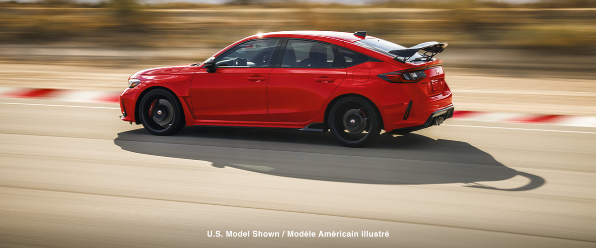 Sideview of red Type R racing on a track.