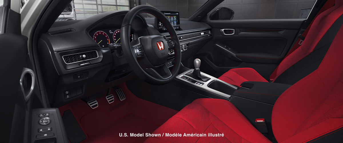 Wide shot of the cockpit, showcasing the red bucket sport seats and entire front dashboard.